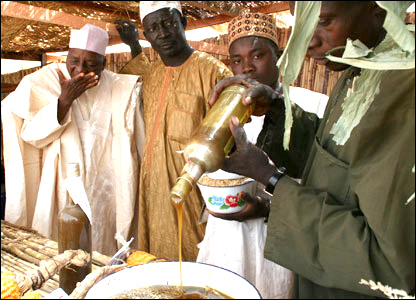 A prospective buyer tastes some locally produced honey.