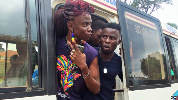 After stopping on the side of the road, LGBT Ugandans emerged from the buses demanding answers from the police. (L. Paulat/VOA)